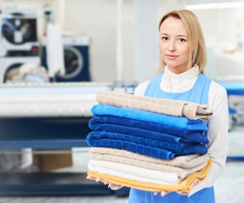 portrait-laundry-worker-background-clothes-hangers-dry-cleaning_154092-5704